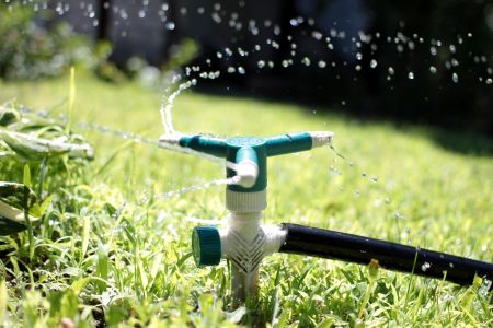 Why hard water well sprinklers leave orange stains on jacksonville houses and how to stop it